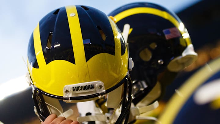 October 20, 2012; Ann Arbor, MI, USA; Michigan Wolverines players hold up their helmets after the game against the Michigan State Spartans at Michigan Stadium. Mandatory Credit: Rick Osentoski-Imagn Images
