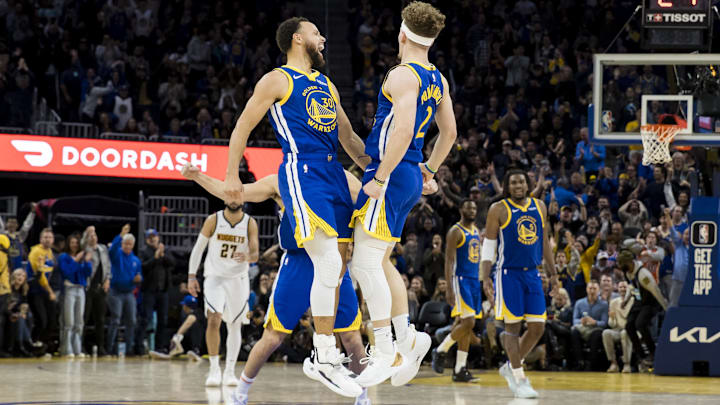 Jan 4, 2024; San Francisco, California, USA; Golden State Warriors guard Brandin Podziemski (2) celebrates with forward Klay Thompson (11) and guard Stephen Curry (30) after he scored against the Denver Nuggets during the second half at Chase Center. Mandatory Credit: John Hefti-Imagn Images