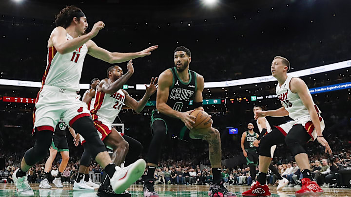 Dec 2, 2024; Boston, Massachusetts, USA; Boston Celtics forward Jayson Tatum (0) looks for an opening around Miami Heat guard Jaime Jaquez Jr. (11), forward Haywood Highsmith (24) and forward Duncan Robinson (55) during the first half at TD Garden. Mandatory Credit: Winslow Townson-Imagn Images