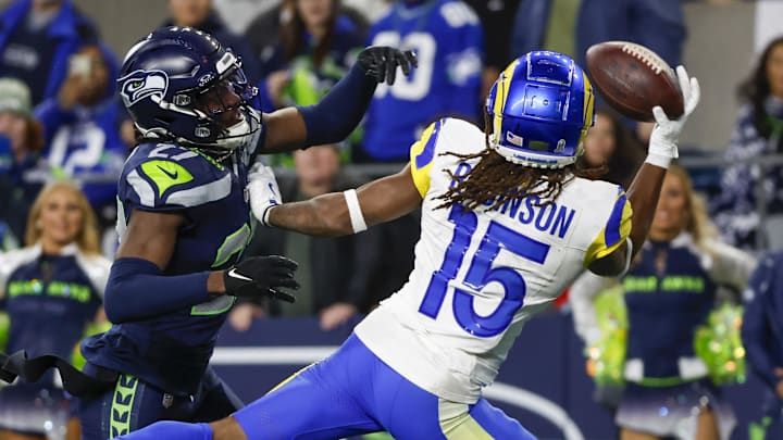 Nov 3, 2024; Seattle, Washington, USA; Los Angeles Rams wide receiver Demarcus Robinson (15) catches a game-winning touchdown pass against Seattle Seahawks cornerback Riq Woolen (27) during overtime at Lumen Field. Mandatory Credit: Joe Nicholson-Imagn Images