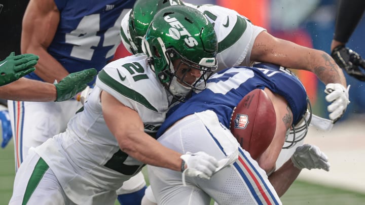 Oct 29, 2023; East Rutherford, NJ; New York Jets safety Ashtyn Davis (21) forces a fumble by New York Giants punt returner Gunner Olszewski (80) during the second half at MetLife Stadium. 