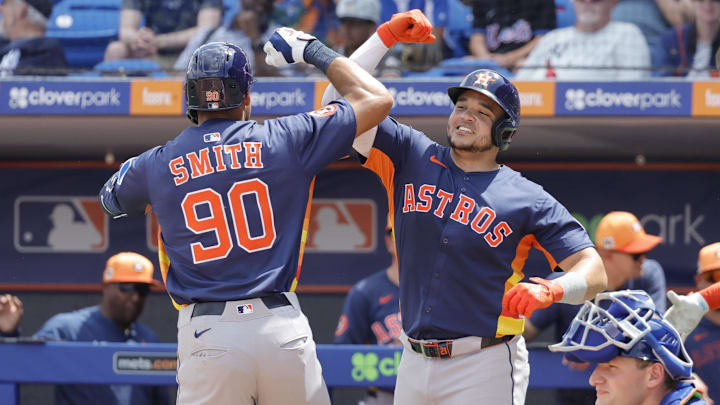 Mar 16, 2025; Port St. Lucie, Florida, USA;  Houston Astros catcher Yainer Diaz (21) and right fielder Cam Smith (90) celebrate after scoring on a two run home run during the second inning against the New York Mets at Clover Park.
