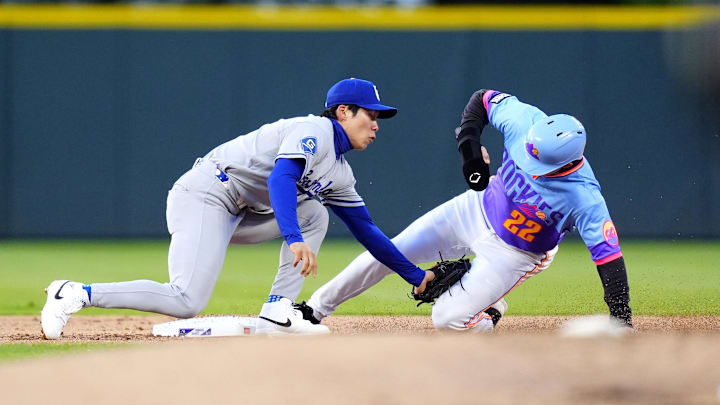 Apr 17, 2026; Denver, Colorado, USA; Colorado Rockies right fielder Mickey Moniak (22) sides safe on a steal at Los Angeles Dodgers second baseman Hyeseong Kim (6) in in the first inning at Coors Field. Mandatory Credit: Ron Chenoy-Imagn Images