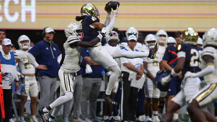 Oct 19, 2024; Atlanta, Georgia, USA; Notre Dame Fighting Irish safety Xavier Watts (0) intercepts a pass in front of Georgia Tech Yellow Jackets wide receiver Abdul Janneh Jr. (4) in the fourth quarter at Mercedes-Benz Stadium. Mandatory Credit: Brett Davis-Imagn Images
