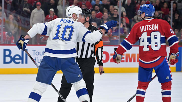 Apr 9, 2026; Montreal, Quebec, CAN; Tampa Bay Lightning forward Corey Perry (10) challenges Montreal Canadiens defenseman Lane Hutson (48) to fight during the second period at the Bell Centre. Mandatory Credit: Eric Bolte-Imagn Images