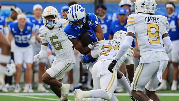 Dec 27, 2025; Orlando, FL, USA; BYU Cougars wide receiver Jojo Phillips (13) runs with the ball as Georgia Tech Yellow Jackets defensive back Tae Harris (27) defends during the first half at Camping World Stadium. Mandatory Credit: Kim Klement Neitzel-Imagn Images Dec 27, 2025; Orlando, FL, USA; BYU Cougars wide receiver Jojo Phillips (13) runs with the ball as Georgia Tech Yellow Jackets defensive back Tae Harris (27) defends during the first half at Camping World Stadium. Mandatory Credit: Kim Klement Neitzel-Imagn Images