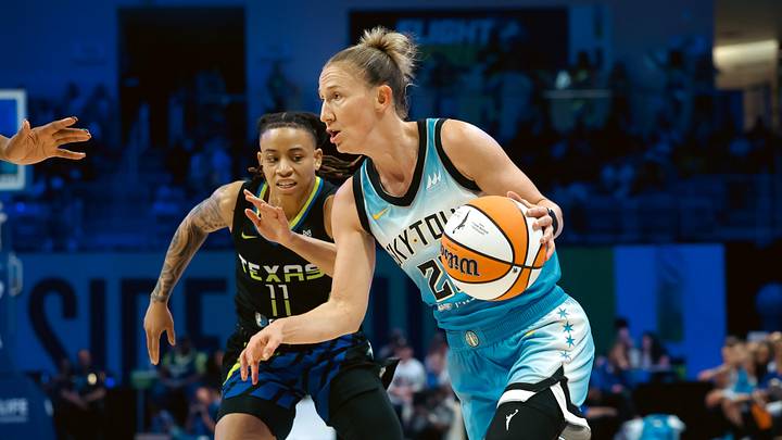 May 31, 2025; Arlington, Texas, USA;  Chicago Sky guard Courtney Vandersloot (22) drives to the basket ahead of Dallas Wings guard JJ Quinerly (11) during the first half at College Park Center. Mandatory Credit: Chris Jones-Imagn Images