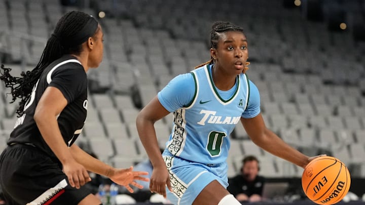 Mar 6, 2023; Fort Worth, TX, USA; Tulane Green Wave guard Kyren Whittington (0) controls the ball against Cincinnati Bearcats guard Mya Jackson (23) during the first half at Dickies Arena. Mar 6, 2023; Fort Worth, TX, USA; Tulane Green Wave guard Kyren Whittington (0) controls the ball against Cincinnati Bearcats guard Mya Jackson (23) during the first half at Dickies Arena.