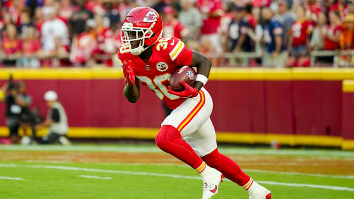 Aug 22, 2025; Kansas City, Missouri, USA; Kansas City Chiefs running back Brashard Smith (30) returns a kickoff during the first half against the Chicago Bears at GEHA Field at Arrowhead Stadium.