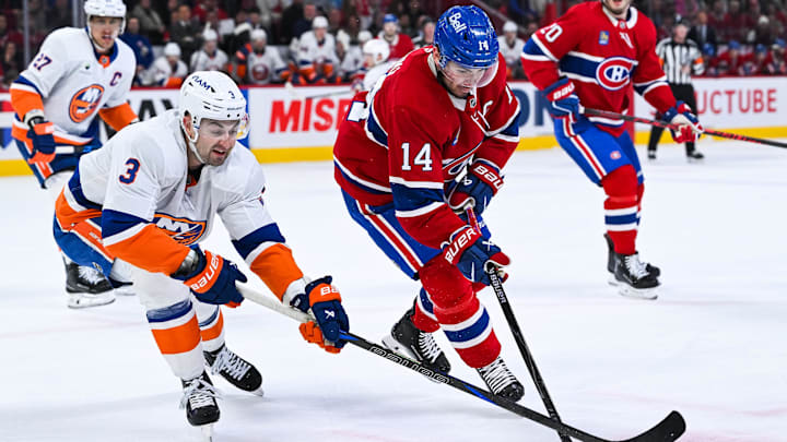 Mar 21, 2026; Montreal, Quebec, CAN; Montreal Canadiens center Nick Suzuki (14) plays the puck against New York Islanders defenseman Adam Pelech (3) during the first period at Bell Centre. Mandatory Credit: David Kirouac-Imagn Images Mar 21, 2026; Montreal, Quebec, CAN; Montreal Canadiens center Nick Suzuki (14) plays the puck against New York Islanders defenseman Adam Pelech (3) during the first period at Bell Centre. Mandatory Credit: David Kirouac-Imagn Images