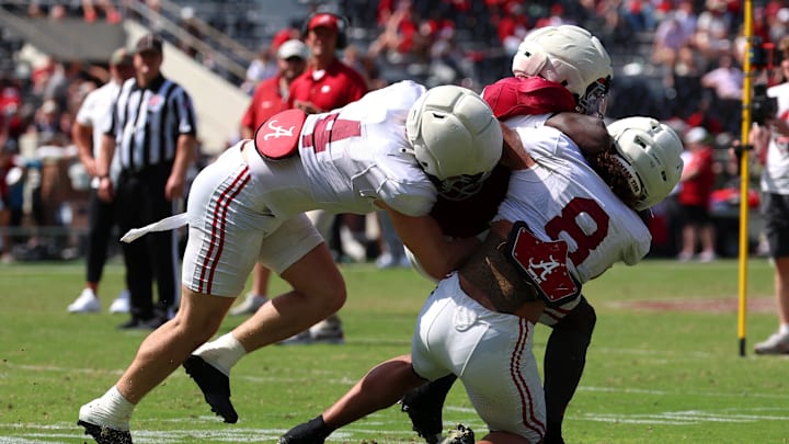 Apr 11, 2026; Tuscaloosa, AL, USA; Alabama Crimson Tide running back Kevin Riley (6) is tackled by linebackers Luke Metz (4) and Justin Hill (8) during the Alabama A-Day spring football scrimmage game at Saban Field at Bryant-Denny Stadium. Mandatory Credit: David Leong-Imagn Images