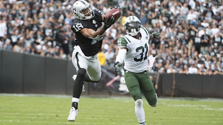 November 1, 2015; Oakland, CA, USA; Oakland Raiders wide receiver Andre Holmes (18) catches a touchdown pass against New York Jets cornerback Antonio Cromartie (31) during the second quarter at O.co Coliseum. Mandatory Credit: Kyle Terada-Imagn Images
