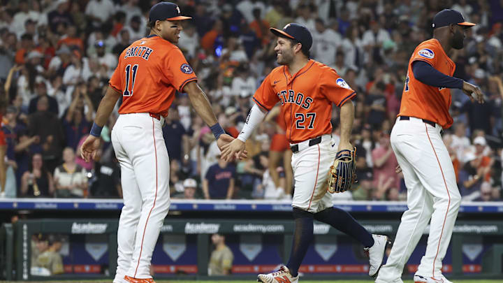 Apr 18, 2025; Houston, Texas, USA; Houston Astros left fielder Jose Altuve (27) celebrates with right fielder Cam Smith (11) after the game against the San Diego Padres at Daikin Park. 