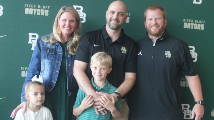 New River Bluff head coach Will Clarke with his family and Athletics Director Andrew Peckham. 