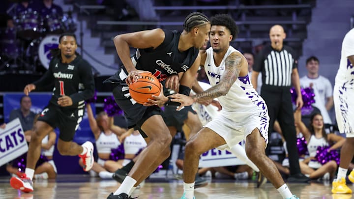 Feb 11, 2026; Manhattan, Kansas, USA; Cincinnati Bearcats forward Baba Miller (18) is guarded by Kansas State Wildcats guard P.J. Haggerty (4) during the second half at Bramlage Coliseum. Mandatory Credit: Scott Sewell-Imagn Images