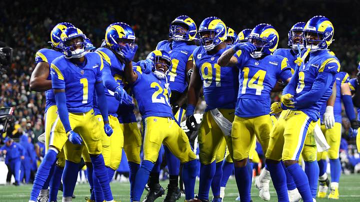 Dec 18, 2025; Seattle, Washington, USA; Los Angeles Rams defensive end Kobie Turner (91) celebrates with teammates after an interception against the Seattle Seahawks in the second half at Lumen Field. Mandatory Credit: Kevin Ng-Imagn Images