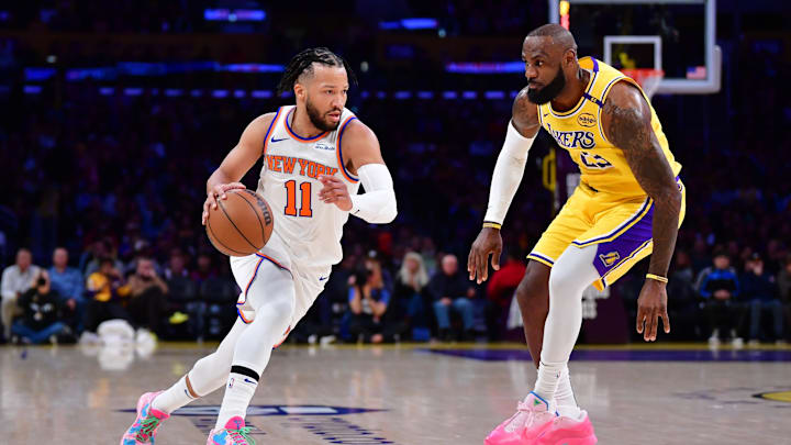 Mar 6, 2025; Los Angeles, California, USA;  New York Knicks guard Jalen Brunson (11) moves the ball against Los Angeles Lakers forward LeBron James (23) during the first half at Crypto.com Arena. Mandatory Credit: Gary A. Vasquez-Imagn Images