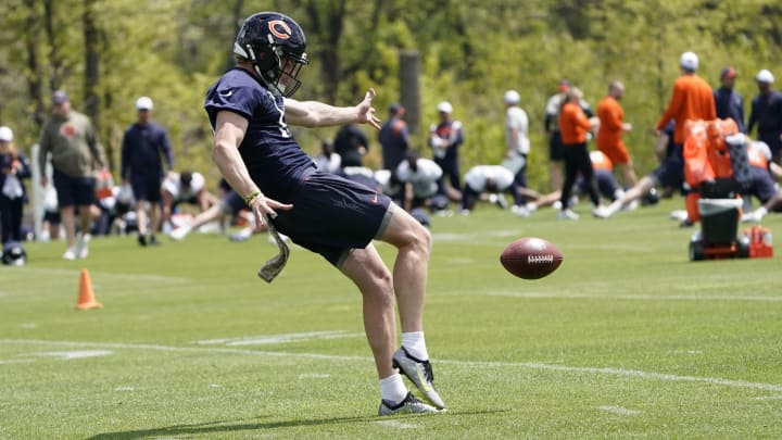Tory Taylor steps into a punt during warmups at Halas Hall practice. The former Iowa punter was the Bears' fourth-round pick.