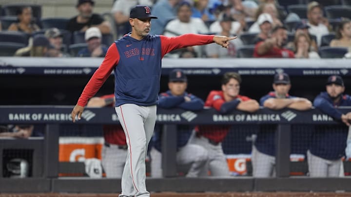 Aug 22, 2025; Bronx, New York, USA; Boston Red Sox manager Alex Cora (13) signals to the umpire that he is checking on Boston Red Sox pitcher Garrett Whitlock (22) (not pictured) to see that he is alright to continue during the eighth inning against the New York Yankees at Yankee Stadium. Mandatory Credit: Gregory Fisher-Imagn Images