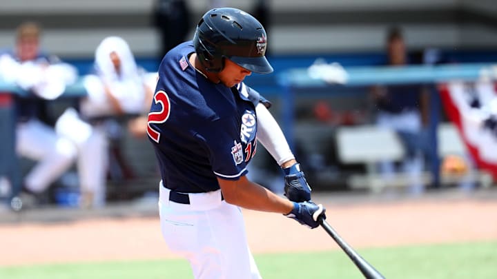 Jun 21, 2019; Bradenton, FL, USA; Team Jones infielder Yohandy Morales (12) singles during the first inning at IMG Academy. Mandatory Credit: Kim Klement-Imagn Images