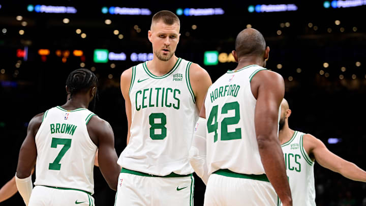 Oct 8, 2023; Boston, Massachusetts, USA; Boston Celtics center Kristaps Porzingis (8) reacts to game action with guard Jaylen Brown (7) and center Al Horford (42) during the first half at TD Garden. Mandatory Credit: Eric Canha-Imagn Images