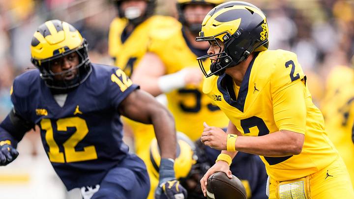 Team Maize quarterback Jadyn Davis (2) runs against Team Blue linebacker Nathaniel Owusu-Boateng (12) during the first half of the spring game at Michigan Stadium in Ann Arbor on Saturday, April 19, 2025. Team Maize quarterback Jadyn Davis (2) runs against Team Blue linebacker Nathaniel Owusu-Boateng (12) during the first half of the spring game at Michigan Stadium in Ann Arbor on Saturday, April 19, 2025.