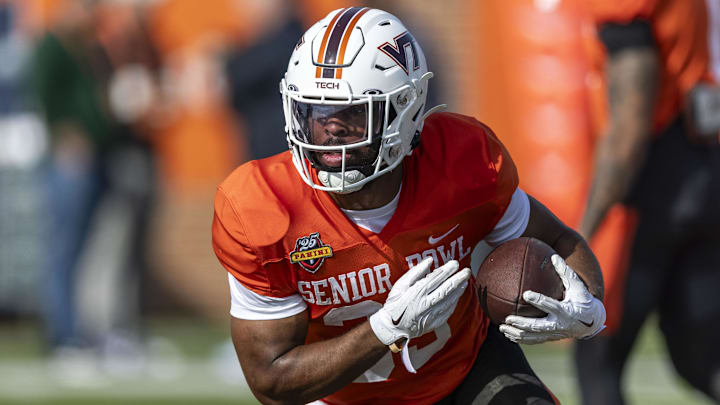 Jan 29, 2025; Mobile, AL, USA; National team running back Bhayshul Tuten of Virginia Tech (33) runs the ball during Senior Bowl practice for the National team at Hancock Whitney Stadium. Mandatory Credit: Vasha Hunt-Imagn Images