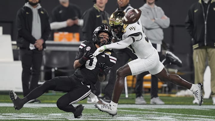 Jan 2, 2026; Charlotte, NC, USA; Mississippi State Bulldogs wide receiver Brenen Thompson (0) makes a opening play catch defended by Wake Forest Demon Deacons defensive back Karon Prunty (3) during the first quarter at Bank of America Stadium. Mandatory Credit: Jim Dedmon-Imagn Images