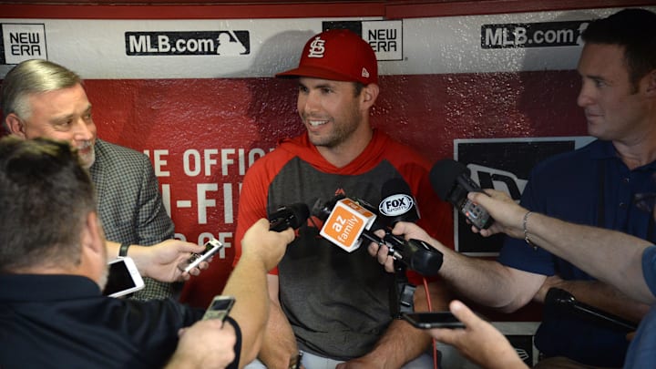 Sep 23, 2019; Phoenix, AZ, USA; St. Louis Cardinals first baseman Paul Goldschmidt (center) speaks to the media in the dugout prior to the game against the Arizona Diamondbacks at Chase Field. Mandatory Credit: Joe Camporeale-Imagn Images