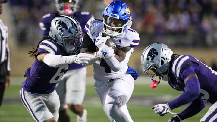 Oct 26, 2024; Manhattan, Kansas, USA; Kansas Jayhawks running back Devin Neal (4) is tackled by Kansas State Wildcats safety Jordan Riley (6) and safety VJ Payne (19) during the third quarter at Bill Snyder Family Football Stadium. Mandatory Credit: Scott Sewell-Imagn Images Oct 26, 2024; Manhattan, Kansas, USA; Kansas Jayhawks running back Devin Neal (4) is tackled by Kansas State Wildcats safety Jordan Riley (6) and safety VJ Payne (19) during the third quarter at Bill Snyder Family Football Stadium. Mandatory Credit: Scott Sewell-Imagn Images