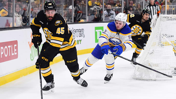 Apr 26, 2026; Boston, Massachusetts, USA;Boston Bruins defenseman Jonathan Aspirot (45) controls the puck from Buffalo Sabres left wing Zach Benson (6) during the second period in game four of the first round of the 2026 Stanley Cup Playoffs at TD Garden. Mandatory Credit: Bob DeChiara-Imagn Images