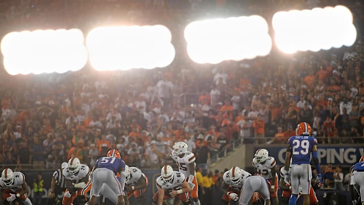 Aug 24, 2019; Orlando, FL, USA; (Editors note in-camera double exposure) Miami Hurricanes quarterback Jarren Williams (15) calls a play at the line during the second half against the Florida Gators at Camping World Stadium. Mandatory Credit: Jasen Vinlove-USA TODAY Sports