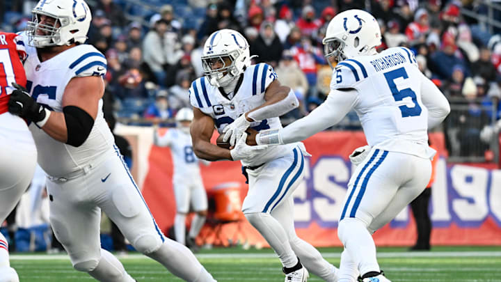 Dec 1, 2024; Foxborough, Massachusetts, USA; Indianapolis Colts quarterback Anthony Richardson (5) hands the ball off to running back Jonathan Taylor (28) during the second half at Gillette Stadium. Mandatory Credit: Eric Canha-Imagn Images