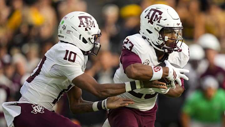 Texas A&M Aggies running back Jamarion Morrow (23) takes the handoff from quarterback Marcel Reed (10) during the first half against the Missouri Tigers at Faurot Field at Memorial Stadium. 