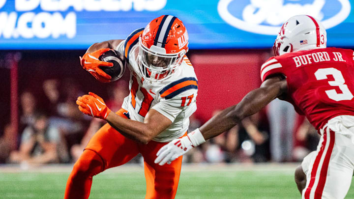 Sep 20, 2024; Lincoln, Nebraska, USA; Illinois Fighting Illini wide receiver Collin Dixon (17) runs after a catch against Nebraska Cornhuskers defensive back Marques Buford Jr. (3) during the second quarter at Memorial Stadium.