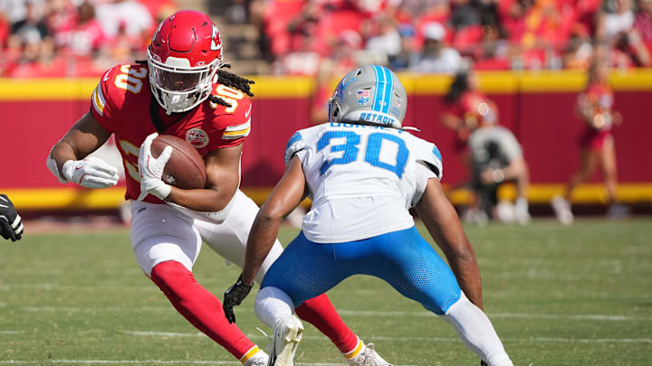 Aug 17, 2024; Kansas City, Missouri, USA; Kansas City Chiefs running back Keaontay Ingram (30) runs the ball as Detroit Lions cornerback Khalil Dorsey (30) defends during the first half at GEHA Field at Arrowhead Stadium. Mandatory Credit: Denny Medley-Imagn Images