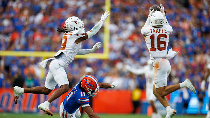 Oct 4, 2025; Gainesville, Florida, USA; Texas Longhorns defensive back Michael Taaffe (16) intercepts a pass to Florida Gators wide receiver Aidan Mizell (11) during the second half at Ben Hill Griffin Stadium. Mandatory Credit: Matt Pendleton-Imagn Images