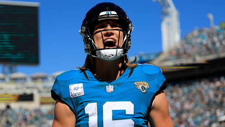 Jacksonville Jaguars quarterback Trevor Lawrence (16) yells after wide receiver Christian Kirk (13),