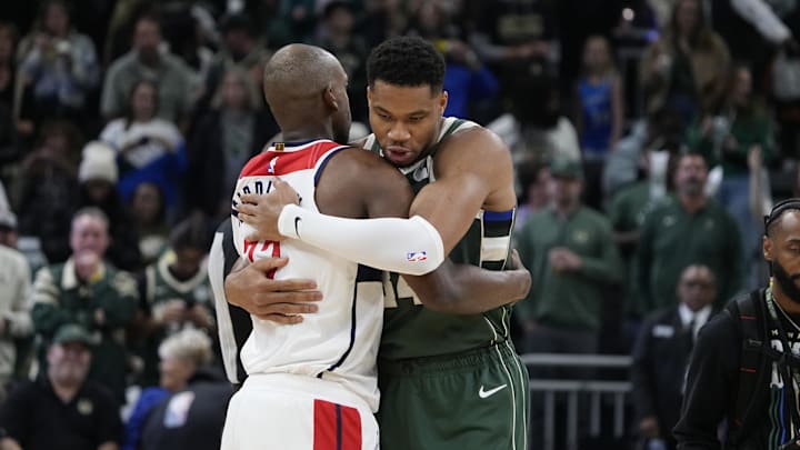 Oct 22, 2025; Milwaukee, Wisconsin, USA; Milwaukee Bucks forward Giannis Antetokounmpo (34) embraces Washington Wizards forward Khris Middleton (22) before their game at Fiserv Forum. It was Washington Wizards forward Khris Middleton (22) first return after being traded laster year. Mandatory Credit: Michael McLoone-Imagn Images