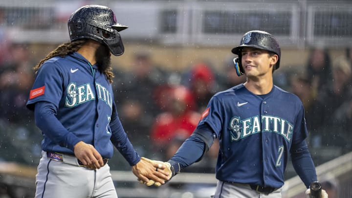 Apr 27, 2026; Minneapolis, Minnesota, USA; Seattle Mariners shortstop J.P. Crawford (3) celebrates with second baseman Cole Young (2) after scoring a run against the Minnesota Twins in the fifth inning at Target Field. Mandatory Credit: Jesse Johnson-Imagn Images