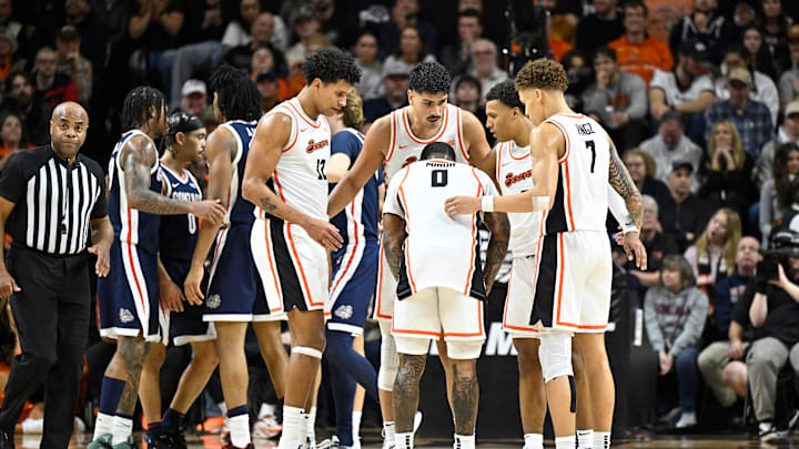 Jan 16, 2025; Corvallis, Oregon, USA; Oregon State Beavers and Gonzaga Bulldogs both huddle on the court during a timeout in the second half at Gill Coliseum. Mandatory Credit: Craig Strobeck-Imagn Images