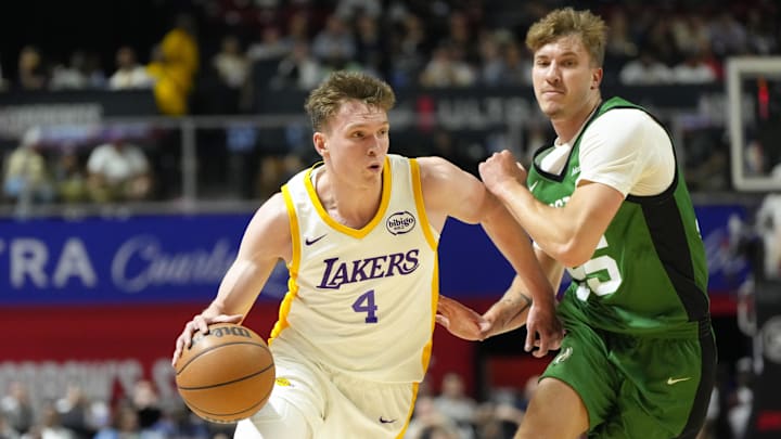 Jul 15, 2024; Las Vegas, NV, USA; Los Angeles Lakers forward Dalton Knecht (4) drives the ball against Boston Celtics guard Baylor Scheierman (55) during the first half at Thomas & Mack Center. Mandatory Credit: Lucas Peltier-Imagn Images