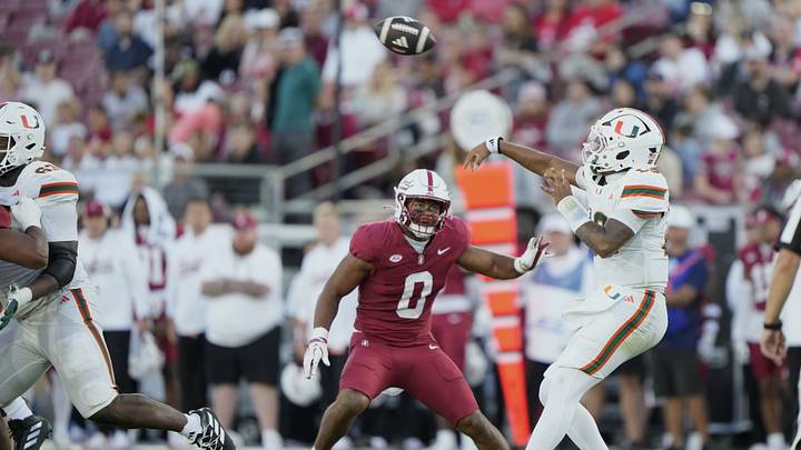 Sep 4, 2026; Stanford, California, USA;  Miami Hurricanes quarterback Darian Mensah (10) throws downfield as Stanford Cardinal linebacker Jahsiah Galvan (0) defends during the first quarter at Stanford Stadium.  Mandatory Credit: Stan Szeto-Imagn Images