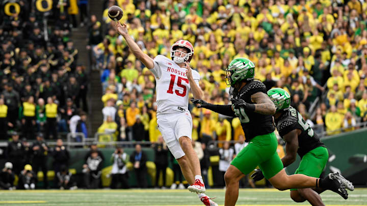 Oct 11, 2025; Eugene, Oregon, USA; Indiana Hoosiers quarterback Fernando Mendoza (15) throws a pass against Oregon Ducks defensive back Xavier Barksdale (30) during the first quarter  at Autzen Stadium. Mandatory Credit: Troy Wayrynen-Imagn Images