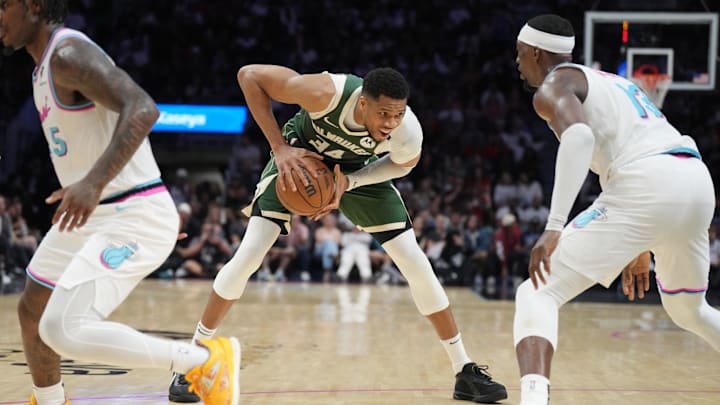 Apr 5, 2025; Miami, Florida, USA;  Milwaukee Bucks forward Giannis Antetokounmpo (34) looks to pass the ball as Miami Heat center Bam Adebayo (13) defends during the second half at Kaseya Center. Mandatory Credit: Jim Rassol-Imagn Images