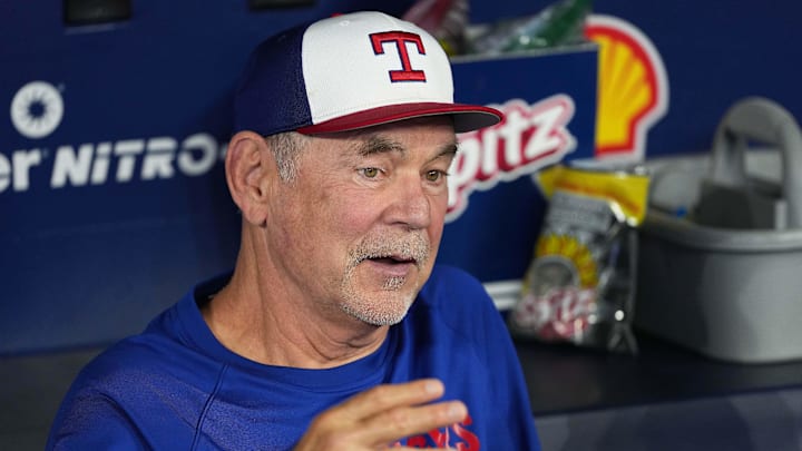 Texas Rangers manager Bruce Bochy (15) talks with the media in the dugout during batting practice before a game against the Toronto Blue Jays.