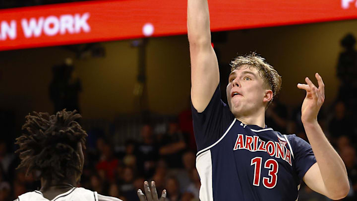 Jan 17, 2026; Orlando, Florida, USA;  Arizona Wildcats center Motiejus Krivas (13) takes a shot over Central Florida Knights center John Bol (7) in the second half at Addition Financial Arena. Mandatory Credit: Russell Lansford-Imagn Images