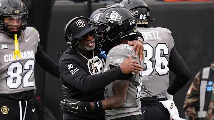 Colorado Buffaloes head coach Deion Sanders hugs wide receiver Travis Hunter following a touchdown.