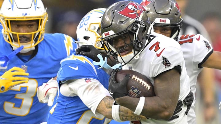 Dec 15, 2024; Inglewood, California, USA; Tampa Bay Buccaneers running back Bucky Irving (7) runs past Los Angeles Chargers cornerback Elijah Molden (22) for a first down in the second half at SoFi Stadium. Mandatory Credit: Jayne Kamin-Oncea-Imagn Images Dec 15, 2024; Inglewood, California, USA; Tampa Bay Buccaneers running back Bucky Irving (7) runs past Los Angeles Chargers cornerback Elijah Molden (22) for a first down in the second half at SoFi Stadium. Mandatory Credit: Jayne Kamin-Oncea-Imagn Images