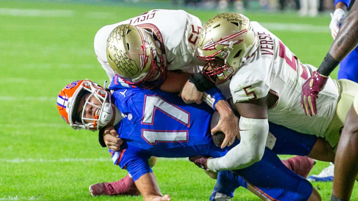 Florida Gators quarterback Max Brown (17) gets stopped by Florida State Seminoles defensive lineman Jared Verse (5) and Florida State Seminoles defensive lineman Braden Fiske (55) during first half action as Florida takes on Florida State at Steve Spurrier Field at Ben Hill Griffin Stadium in Gainesville, FL on Saturday, November 25, 2023. [Alan Youngblood/Gainesville Sun]